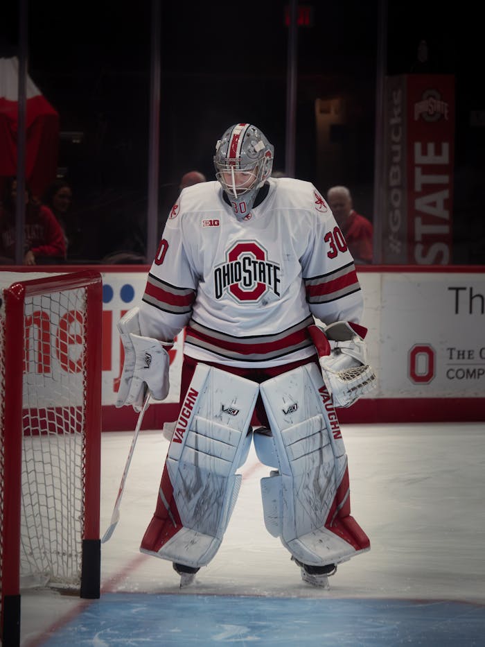 Ice hockey goalie from Ohio State in gear during a game, ready at the rink.